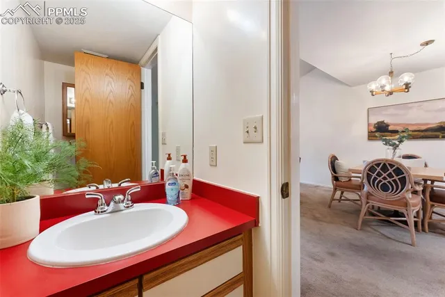 a view of a dining room with furniture and chandelier