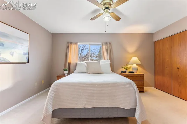 a bedroom with a bed and painting on the wall