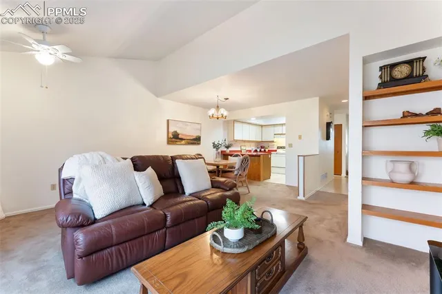 a living room with furniture kitchen and a table