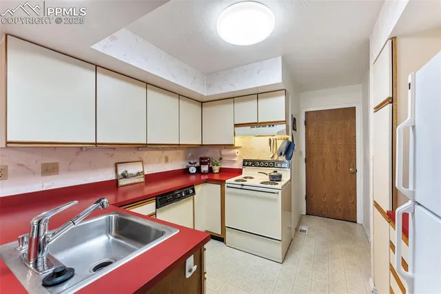 a kitchen with a sink cabinets and stainless steel appliances