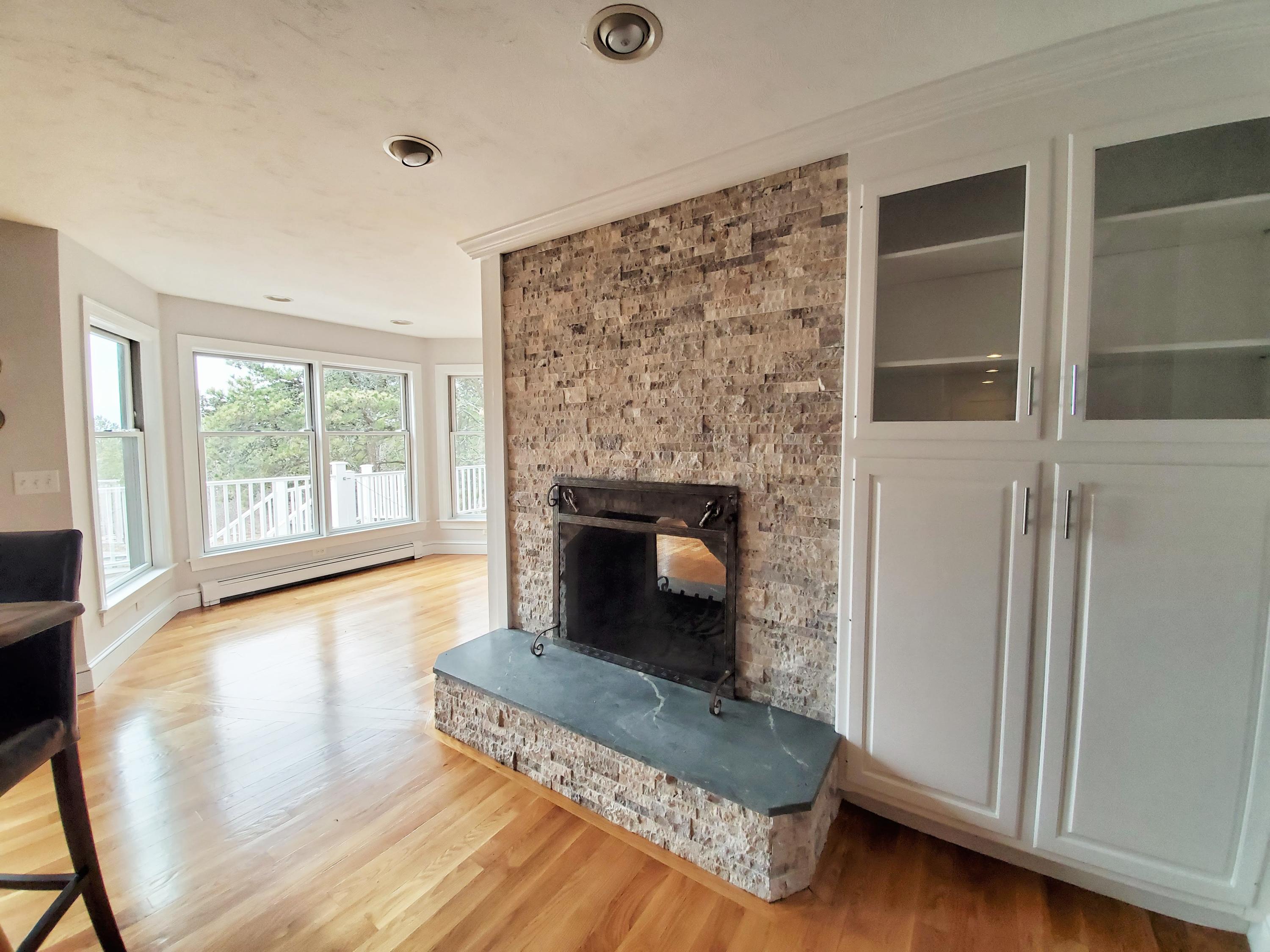 50 Major Doane Road Wellfleet, MA 02667 - Photo 15 of 91 a living room with a fireplace