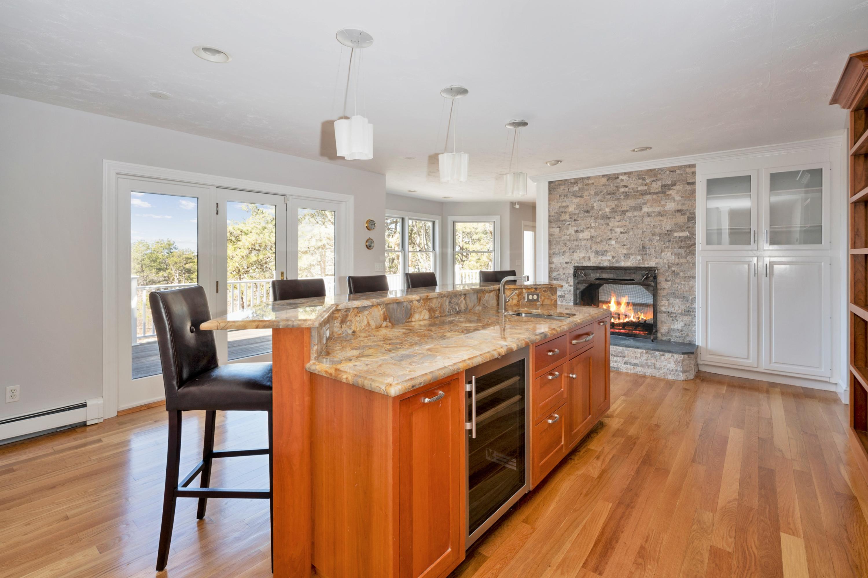 50 Major Doane Road Wellfleet, MA 02667 - Photo 18 of 91 a large kitchen with stainless steel appliances granite countertop a stove and wooden floor