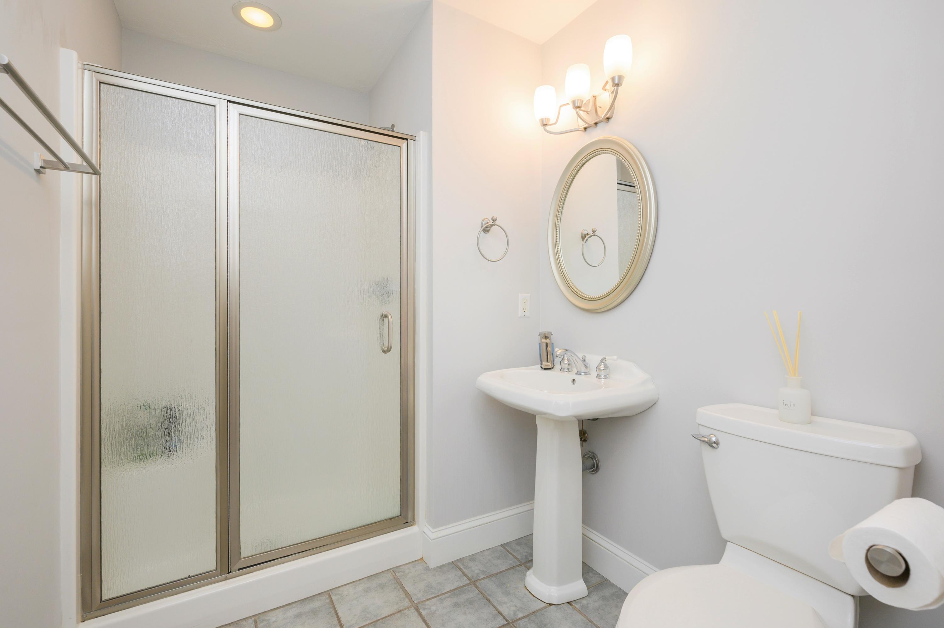 50 Major Doane Road Wellfleet, MA 02667 - Photo 24 of 91 a bathroom with a toilet a sink and a mirror