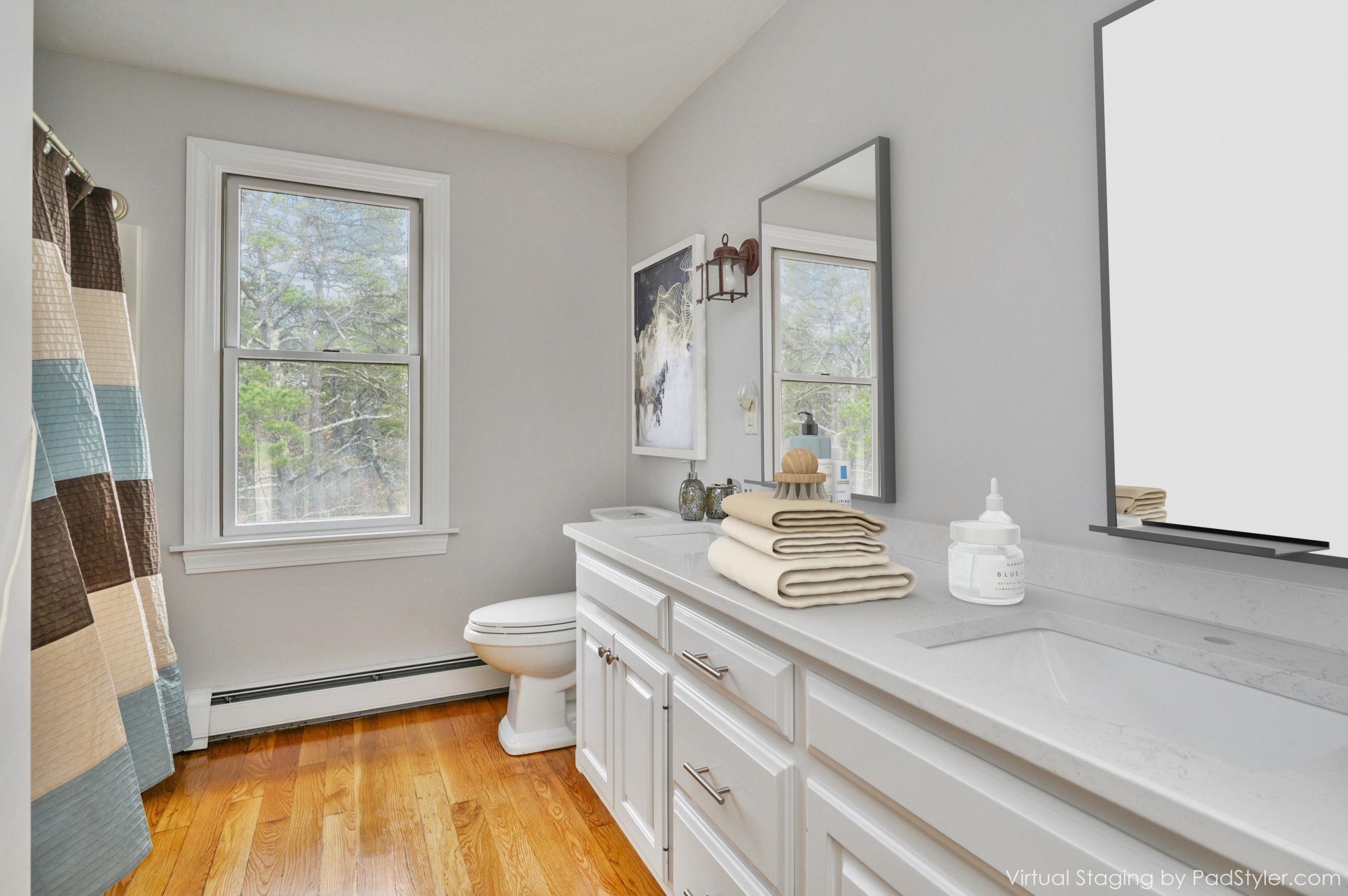 50 Major Doane Road Wellfleet, MA 02667 - Photo 42 of 91 a bathroom with a granite countertop sink a toilet a mirror and window