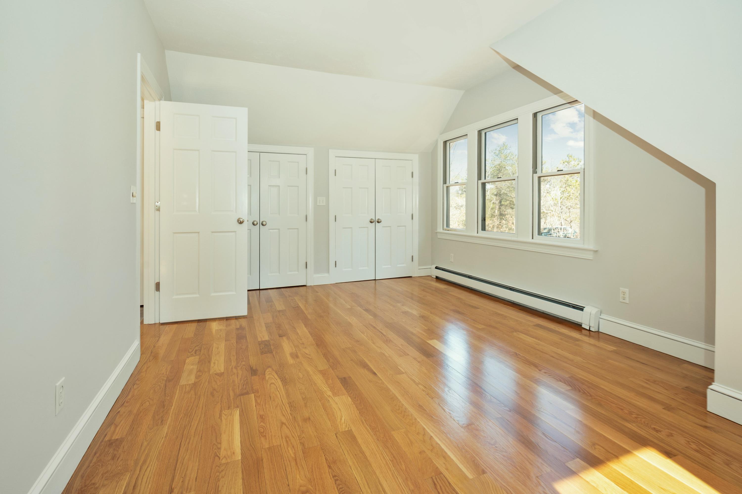 50 Major Doane Road Wellfleet, MA 02667 - Photo 45 of 91 an empty room with wooden floor and windows