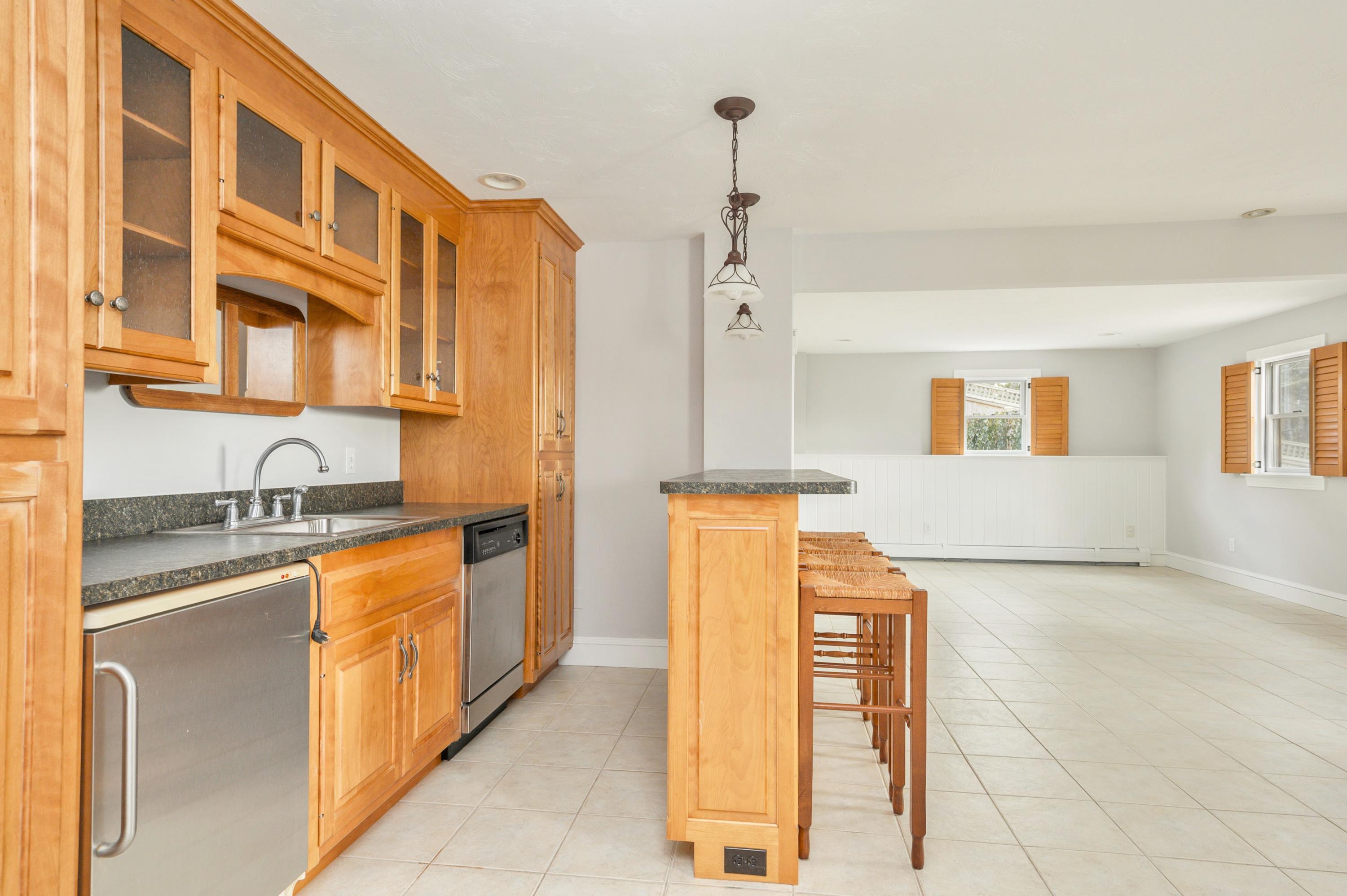 50 Major Doane Road Wellfleet, MA 02667 - Photo 54 of 91 a kitchen with stainless steel appliances granite countertop a sink a stove and refrigerator