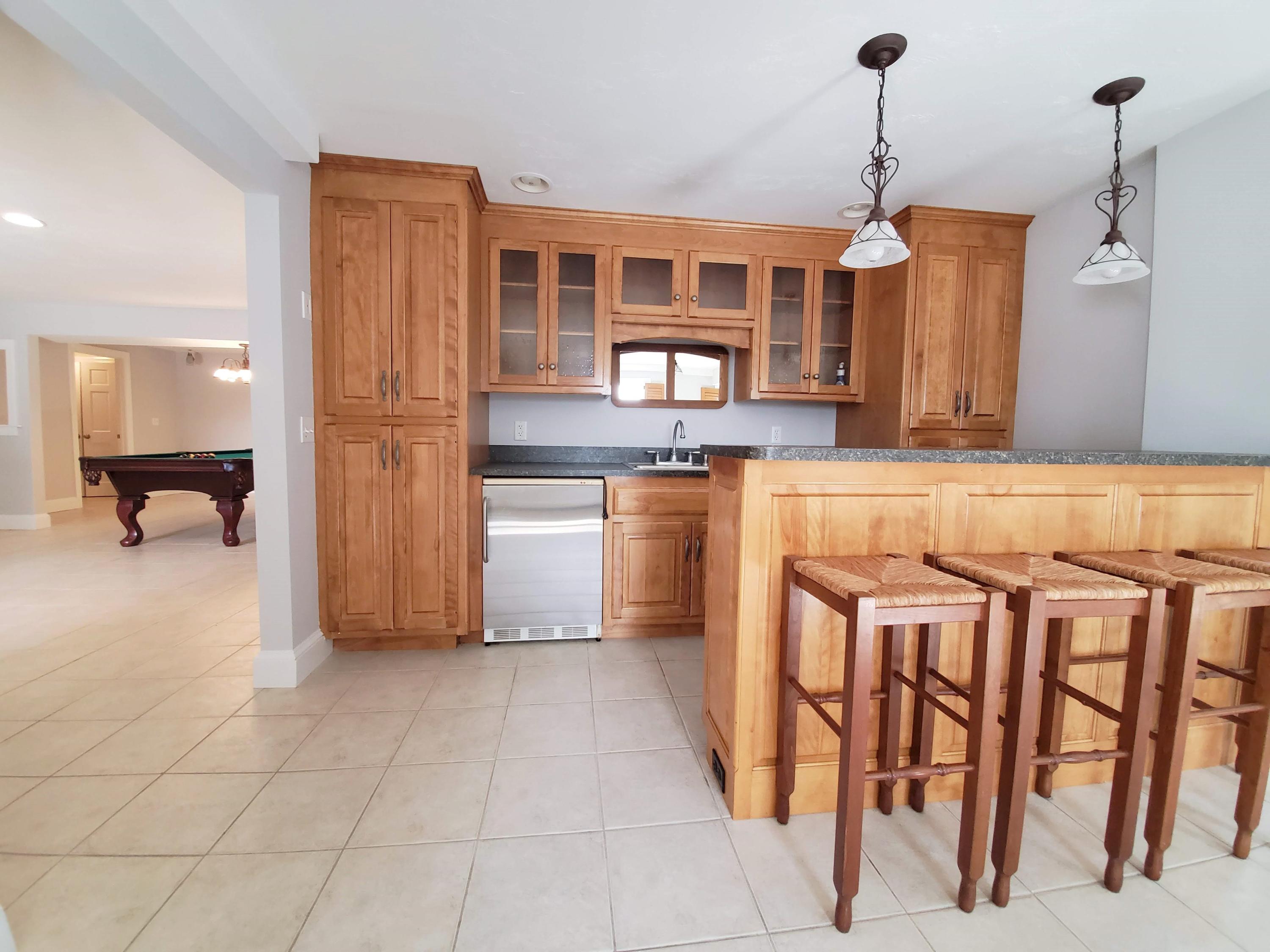 50 Major Doane Road Wellfleet, MA 02667 - Photo 55 of 91 a kitchen with stainless steel appliances granite countertop a refrigerator and a stove