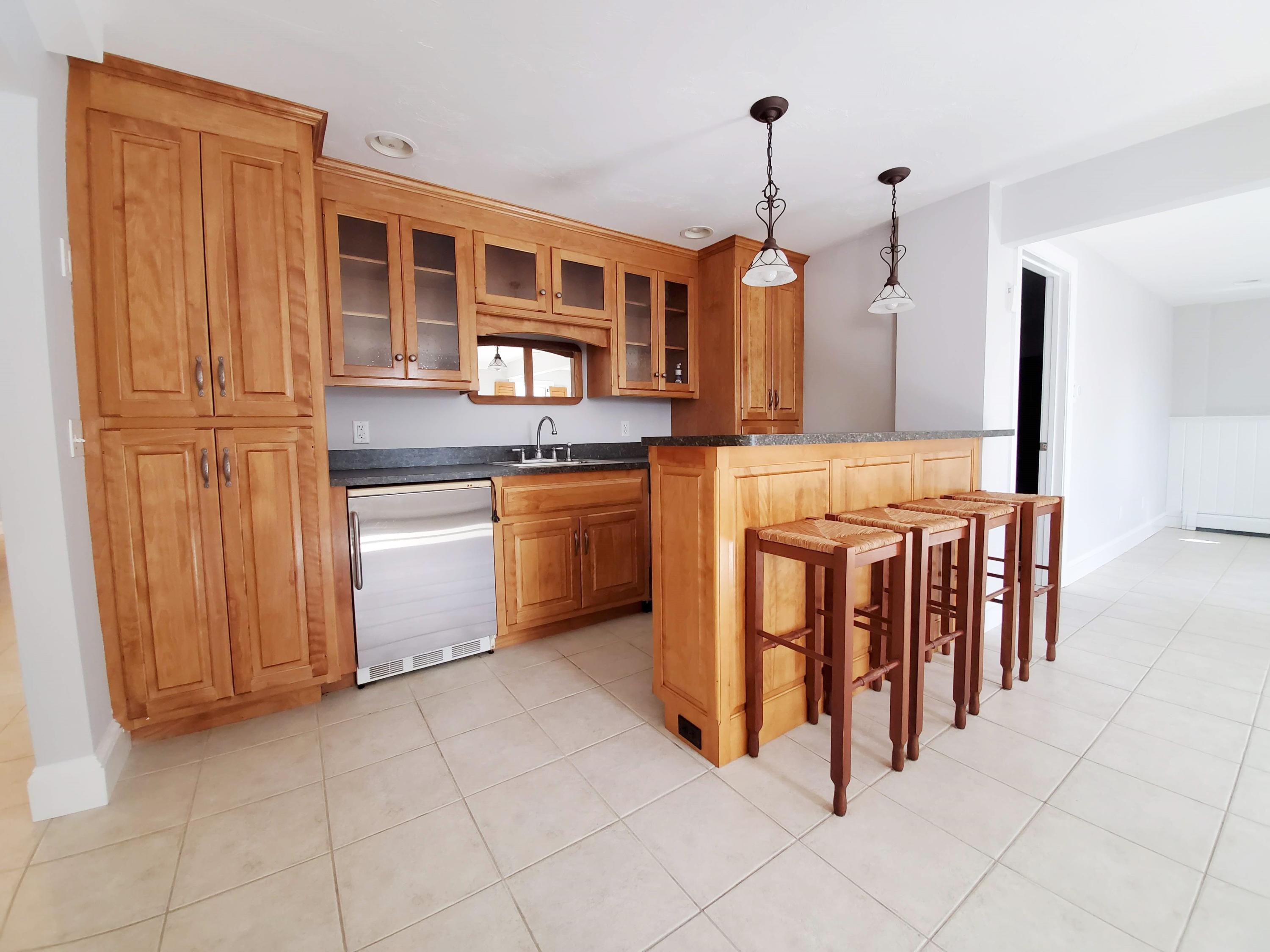 50 Major Doane Road Wellfleet, MA 02667 - Photo 57 of 91 a kitchen with stainless steel appliances granite countertop a stove top oven a sink and a refrigerator