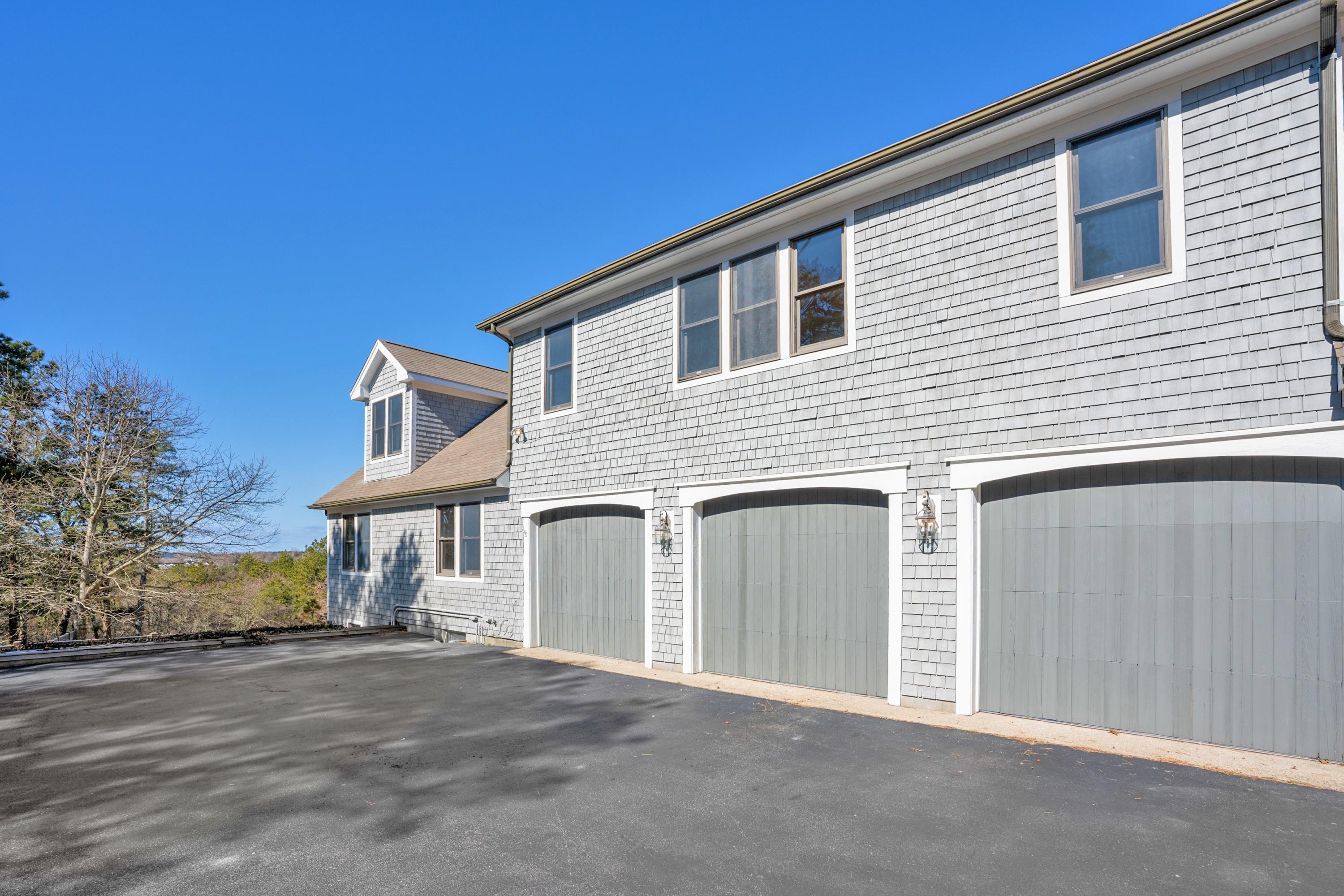 50 Major Doane Road Wellfleet, MA 02667 - Photo 71 of 91 a front view of a house with a garage