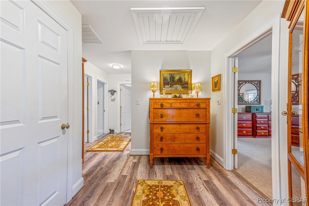 867 Holly Point Road Mathews, VA 23109 - Photo 25 of 48 Corridor featuring wood-type flooring