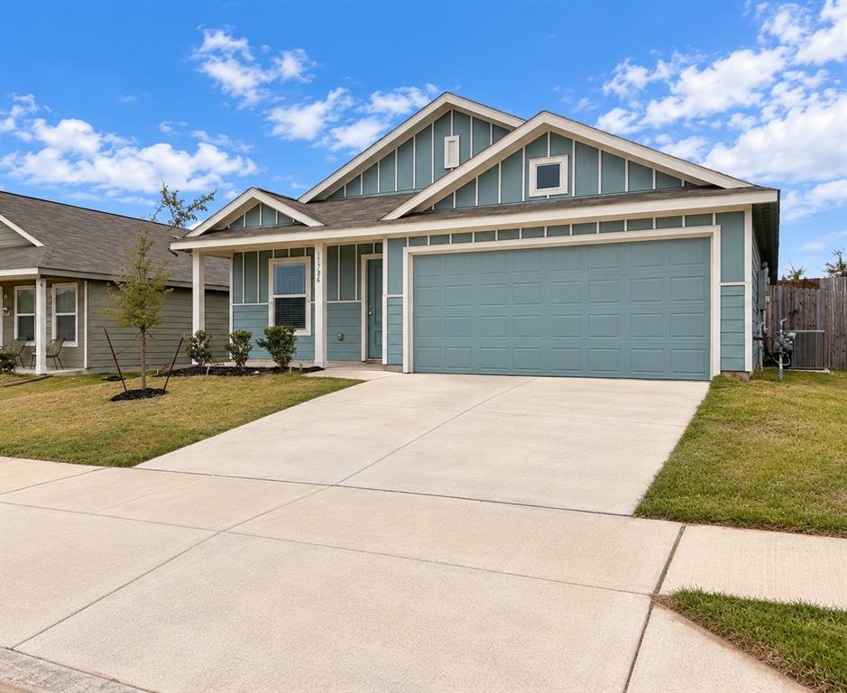 11726 Bone Spg Drive Rhome, TX 76078 - Photo 1 of 29 Attractive single-story home featuring blue siding with crisp white trim, an attached two-car garage, covered front entry, and landscaped front yard.