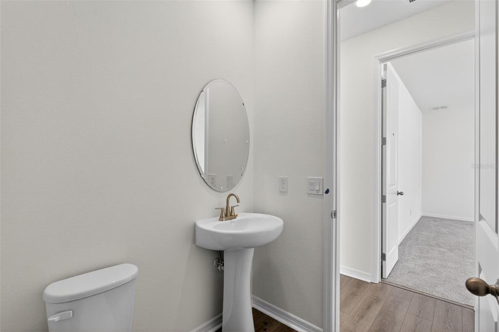 5777 Haystack Drive St. Cloud, FL 34771 - Photo 15 of 37 a bathroom with a sink a mirror and a toilet