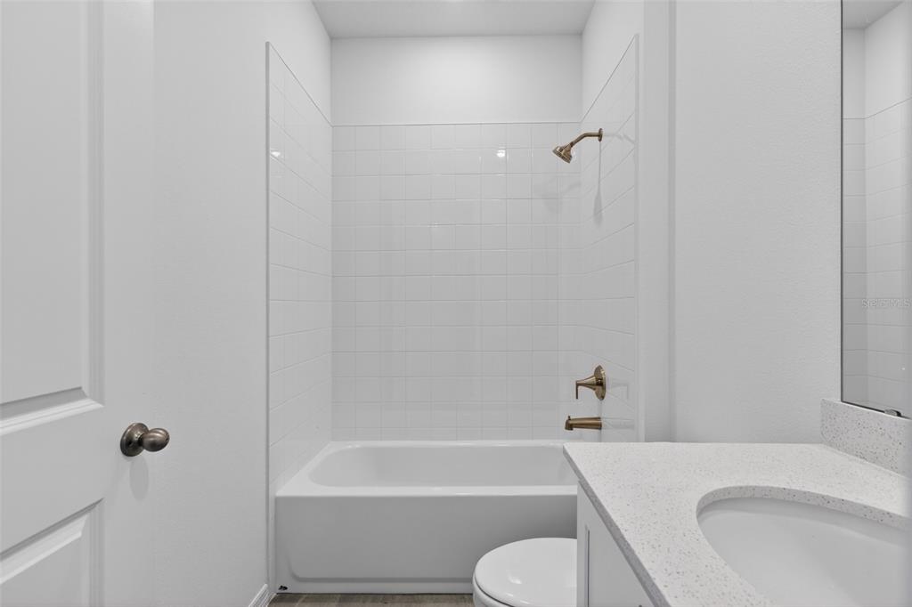 5777 Haystack Drive St. Cloud, FL 34771 - Photo 20 of 37 a bathroom with a toilet and a bath tub