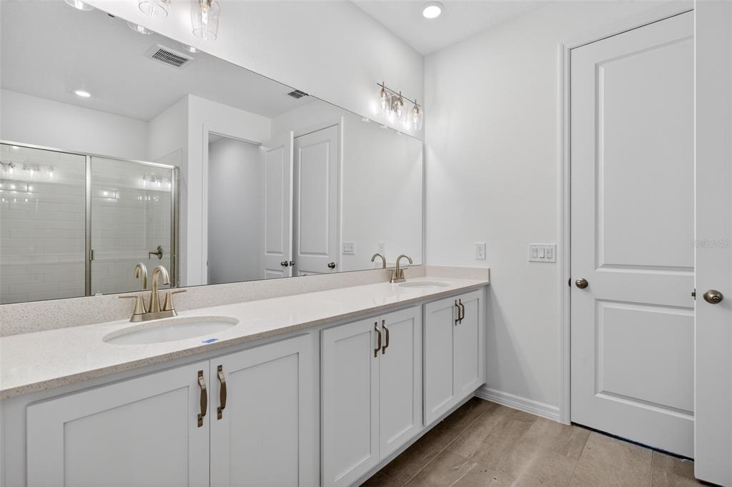 5777 Haystack Drive St. Cloud, FL 34771 - Photo 24 of 37 a bathroom with double vanity sink and a mirror