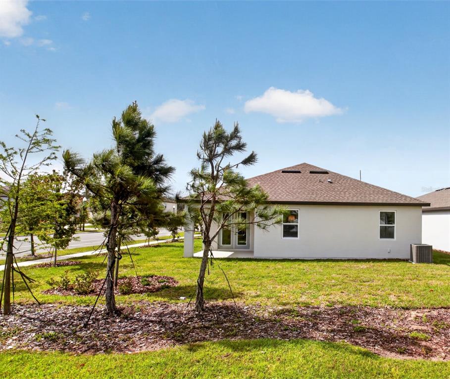 5777 Haystack Drive St. Cloud, FL 34771 - Photo 31 of 37 a front view of a house with garden