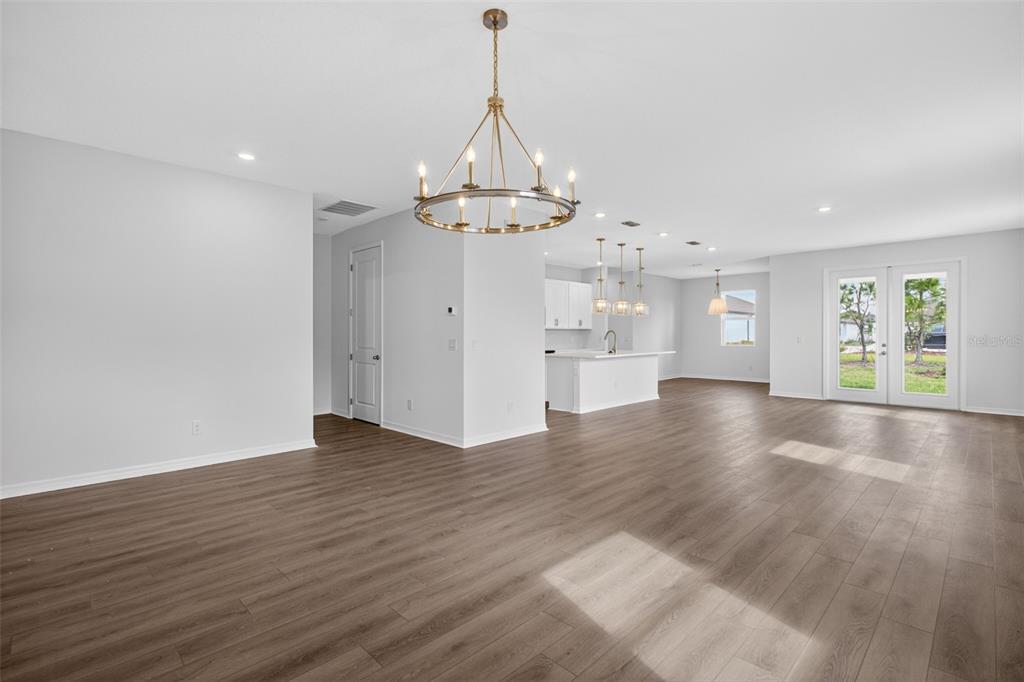 5777 Haystack Drive St. Cloud, FL 34771 - Photo 7 of 37 a view of an empty room with wooden floor and a window