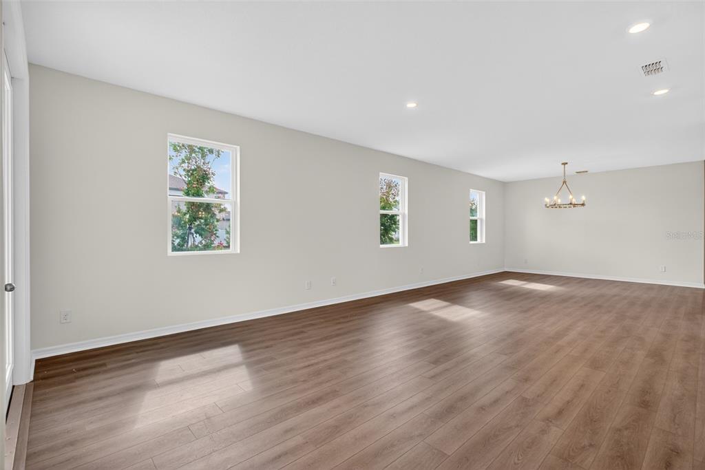 5777 Haystack Drive St. Cloud, FL 34771 - Photo 8 of 37 an empty room with wooden floor and windows