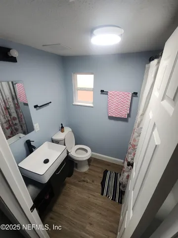 a bathroom with a sink mirror and toilet