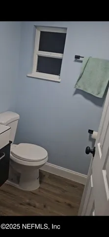a bathroom with a toilet and a vanity