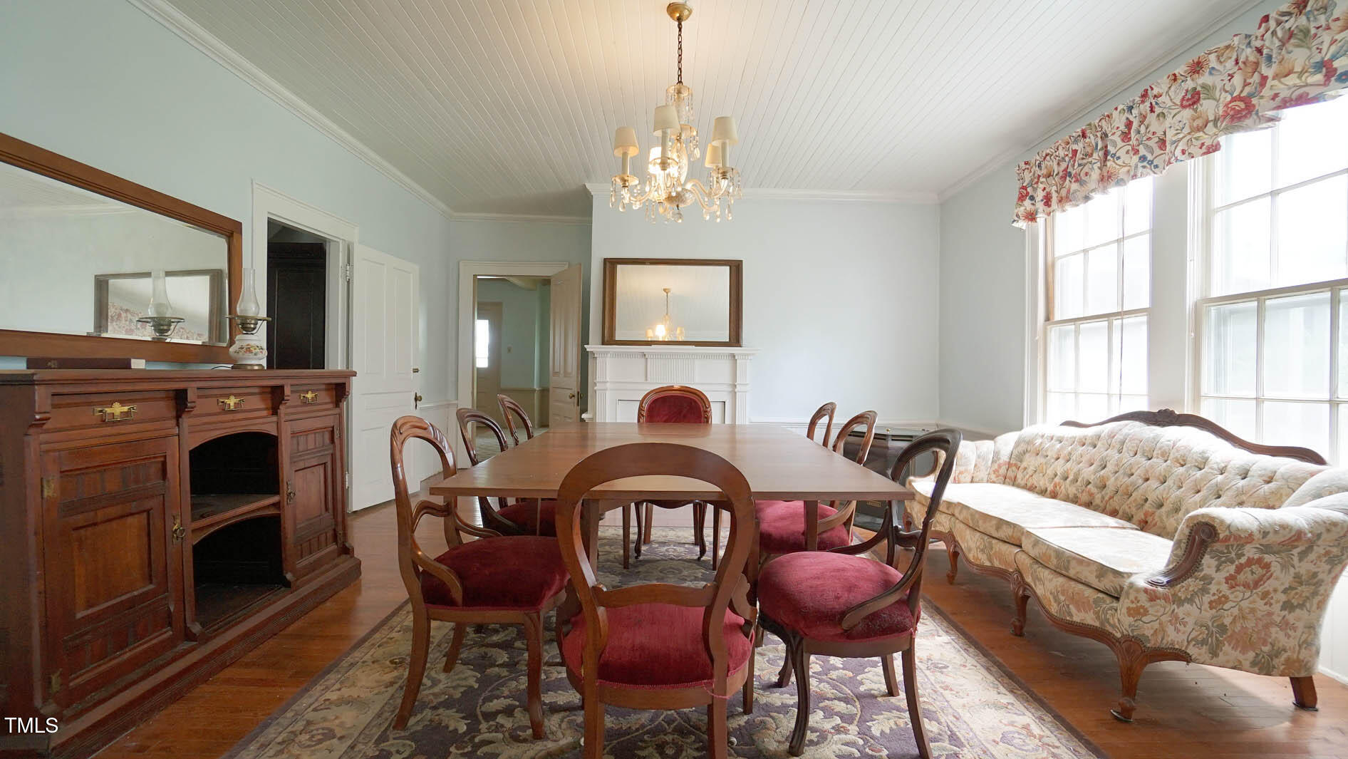 9358 Main Street Castalia, NC 27816 - Photo 38 of 92 a living room with furniture a fireplace and a flat screen tv