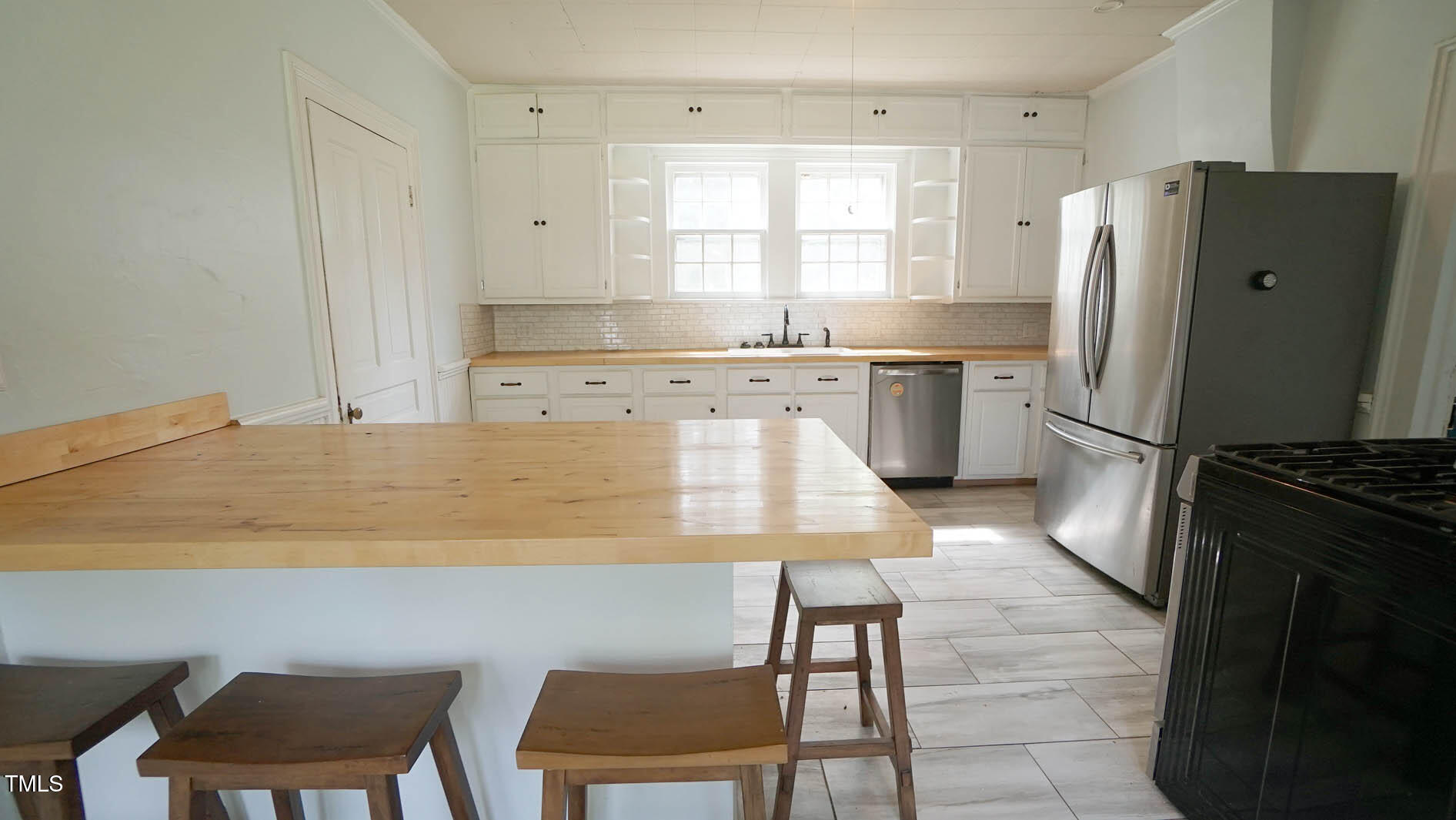 9358 Main Street Castalia, NC 27816 - Photo 43 of 92 a kitchen with a refrigerator a table and chairs in it
