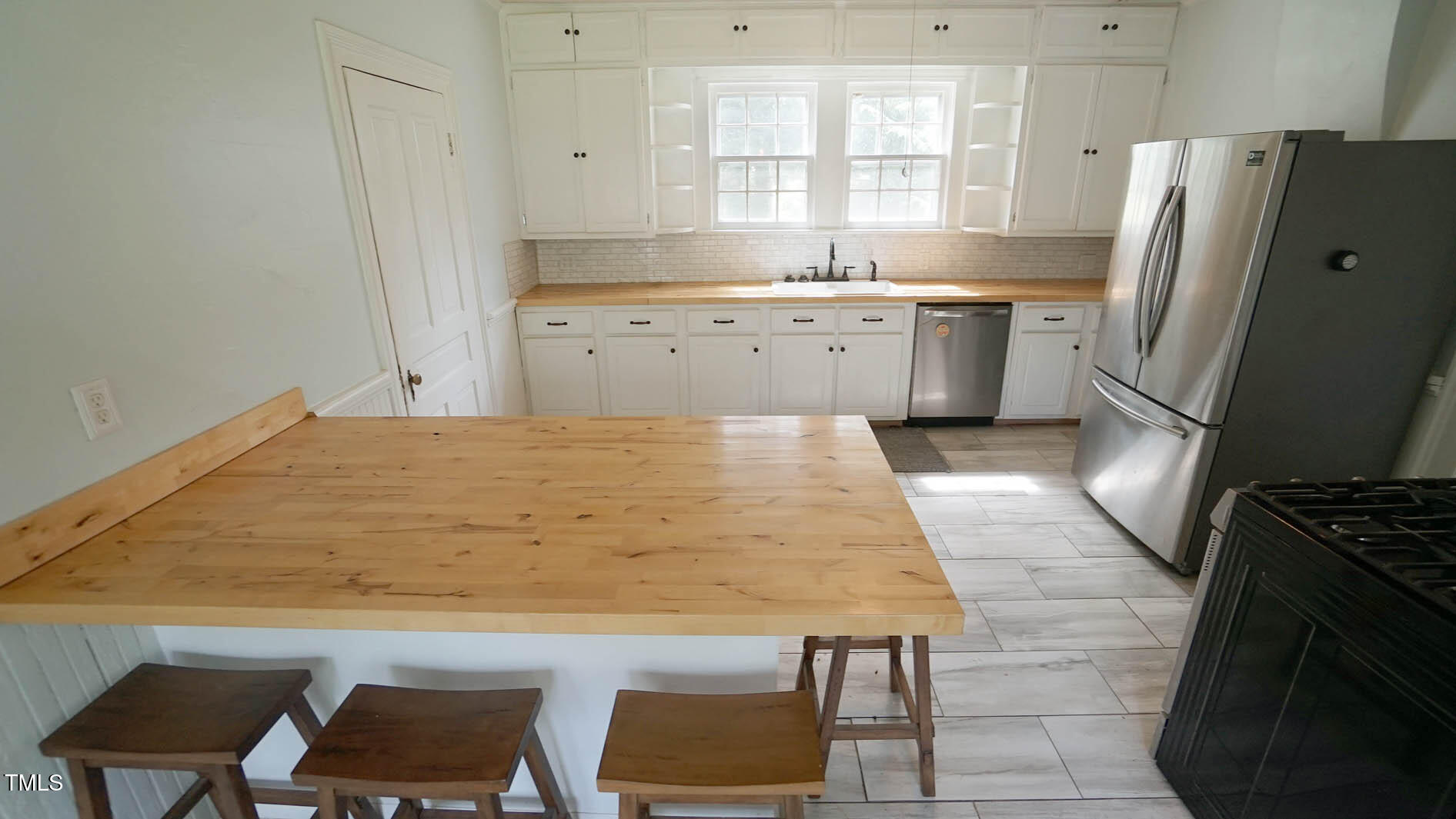 9358 Main Street Castalia, NC 27816 - Photo 44 of 92 a kitchen with granite countertop a refrigerator stove and sink
