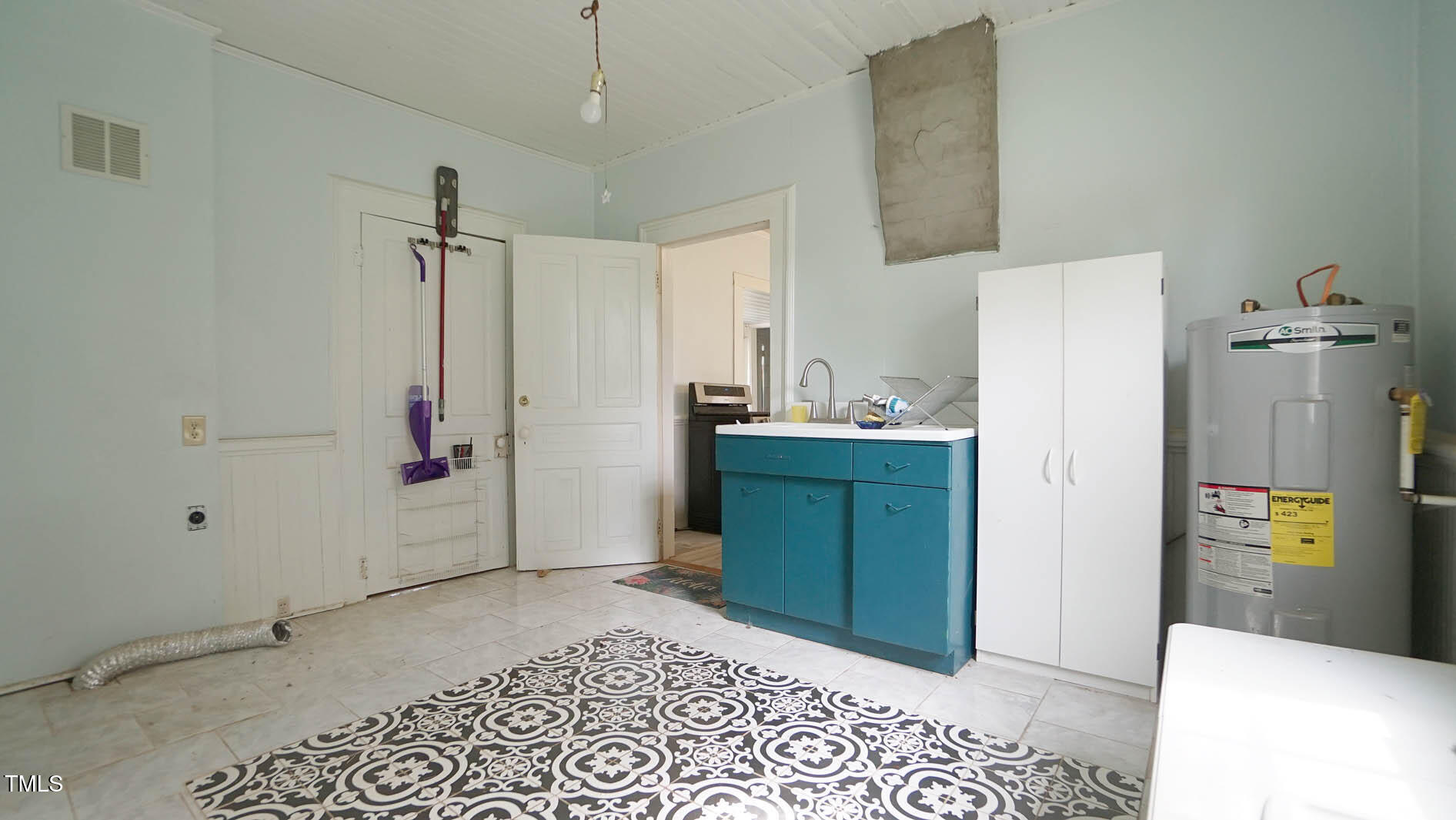 9358 Main Street Castalia, NC 27816 - Photo 48 of 92 a room with a refrigerator and a dresser