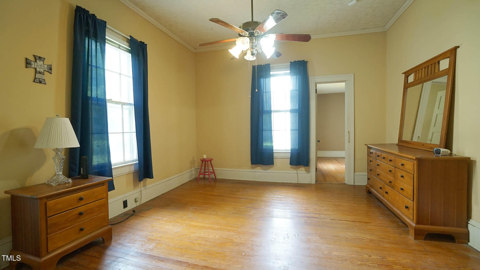 9358 Main Street Castalia, NC 27816 - Photo 57 of 92 a view of a room with cabinet mirror and a chandelier fan