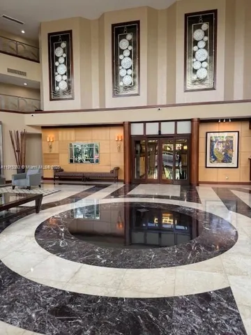 a living room with furniture and painting on the wall