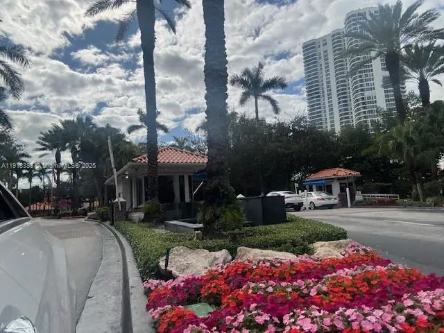 a front view of a house with a yard and fountain