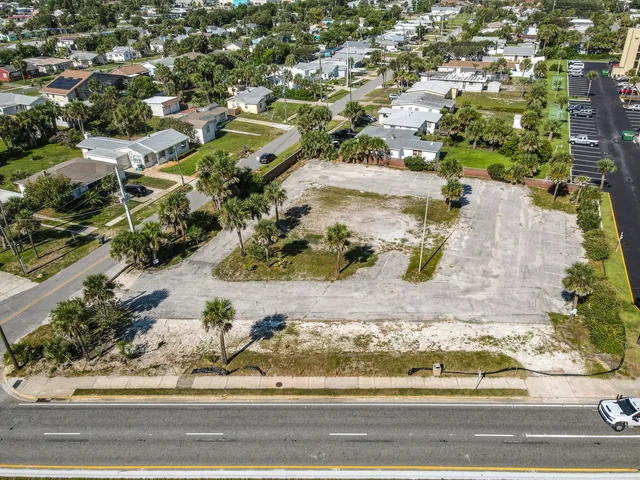 an aerial view of residential houses with outdoor space and swimming pool