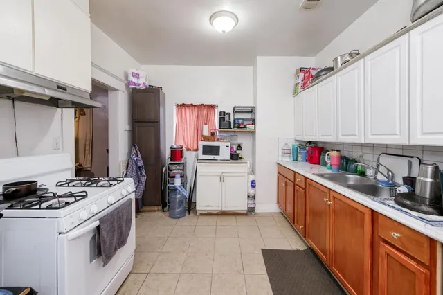 a kitchen with stainless steel appliances a stove refrigerator and a sink