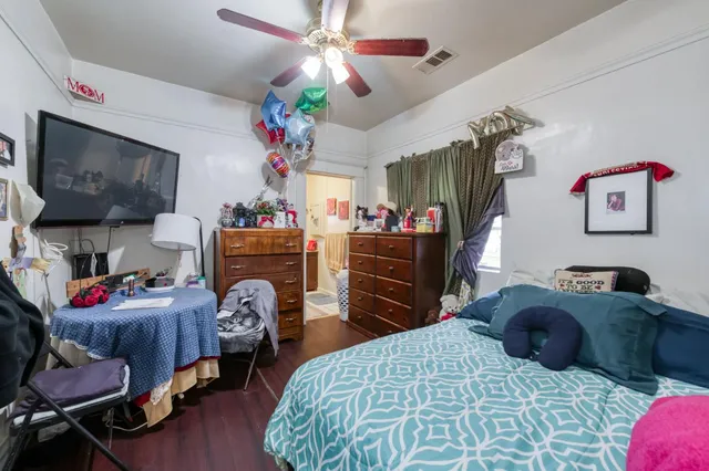 a bedroom with furniture and a flat screen tv