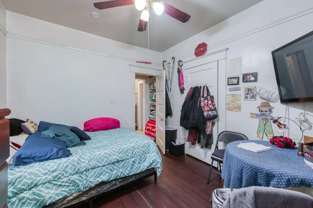 a bedroom with a bed and a flat screen tv