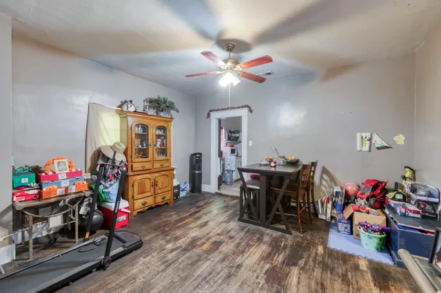 a living room filled with furniture and a wooden floor