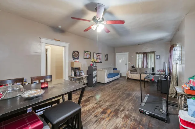 a living room with furniture a wooden floor and musical instruments