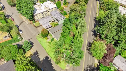 an aerial view of a residential houses with yard