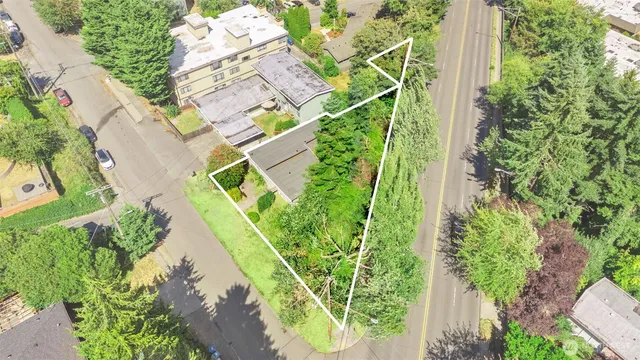 a front view of a house with a garden and trees