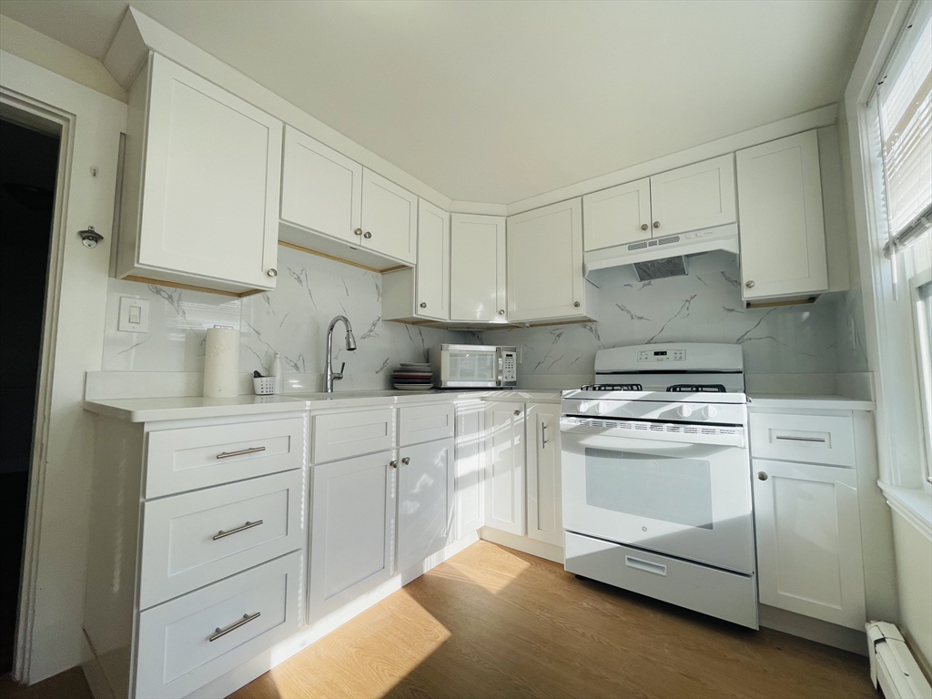 a kitchen with cabinets stainless steel appliances and a sink