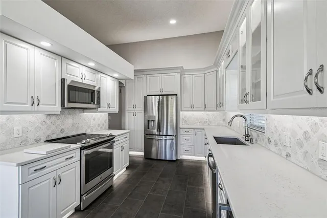 a kitchen with a sink stove and refrigerator