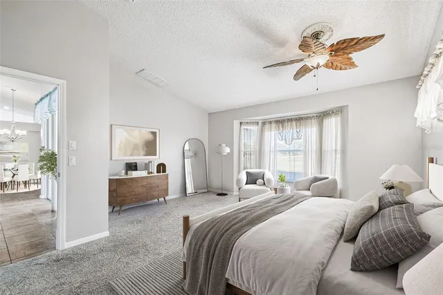 a bedroom with a large bed and a window