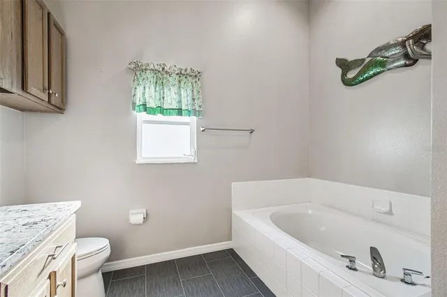 a white bath tub sitting next to a toilet