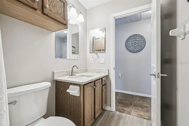 a bathroom with a toilet a sink and a mirror