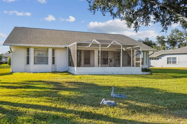 an aerial view of a house with a garden and lake view