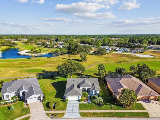 a view of swimming pool in front of house with yard