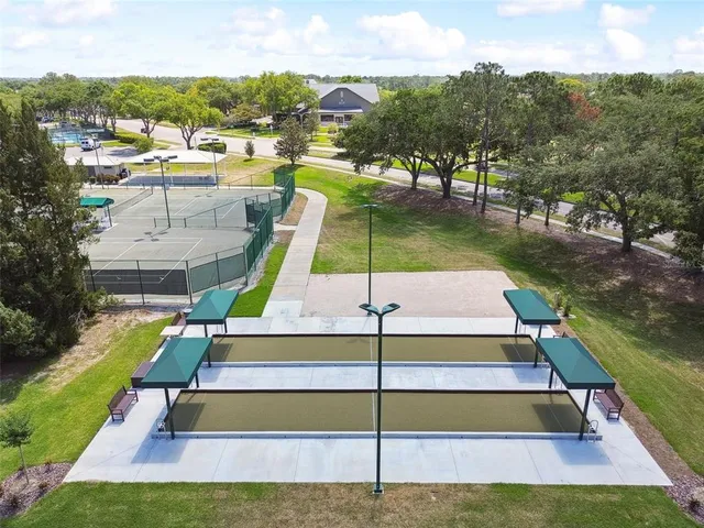 a dining room with lots of wooden furniture and a chandelier