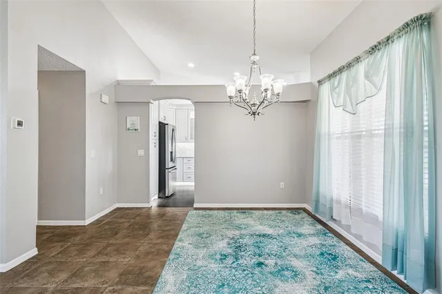 a view of a chandelier in big room and chandelier