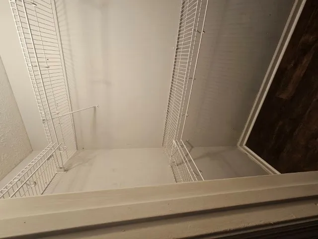 an empty room with fan and windows