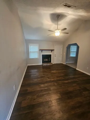 wooden floor in an empty room with a fireplace