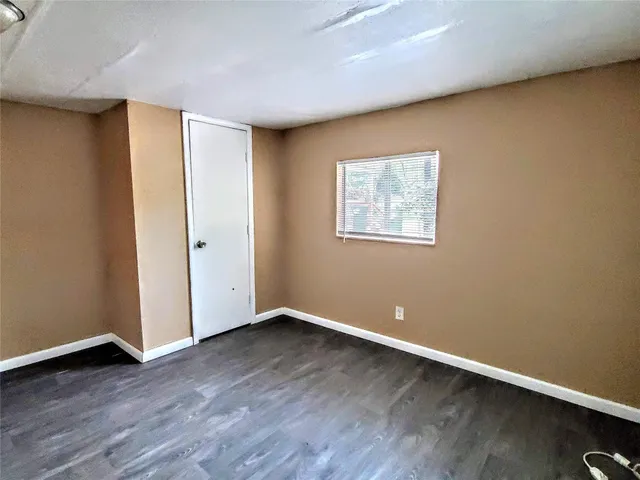 a view of room with wooden floor and window